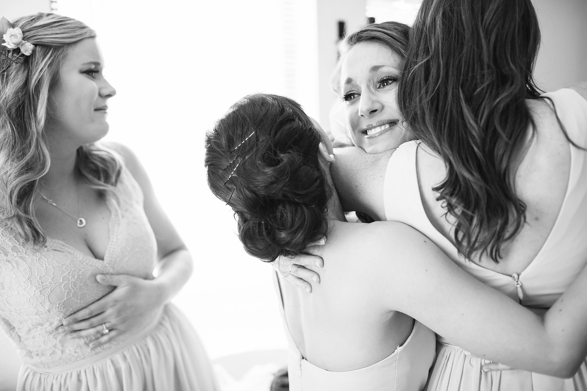 A bride hugs her bridesmaids during her Los Abrigados Sedona wedding