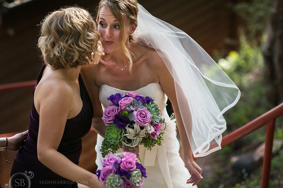 L'Auberge Weddings ~ the bride and bridesmaid share a kiss of encouragement before the wedding ceremony