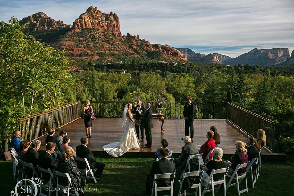 L'Auberge Weddings ~ and overall scene of the ceremony and Sedona red rocks in the background at Spirit Song ceremony location