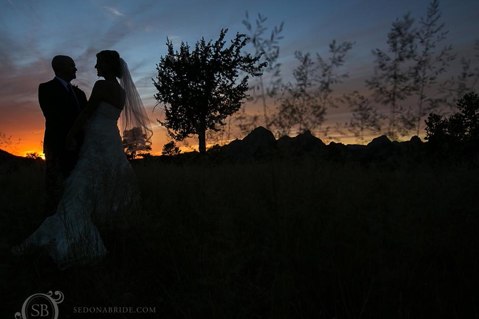 L'Auberge Weddings ~ Fire in the sky with the beautiful Sedona desert sunset and silhouettes of the bride and groom after their wedding ceremony