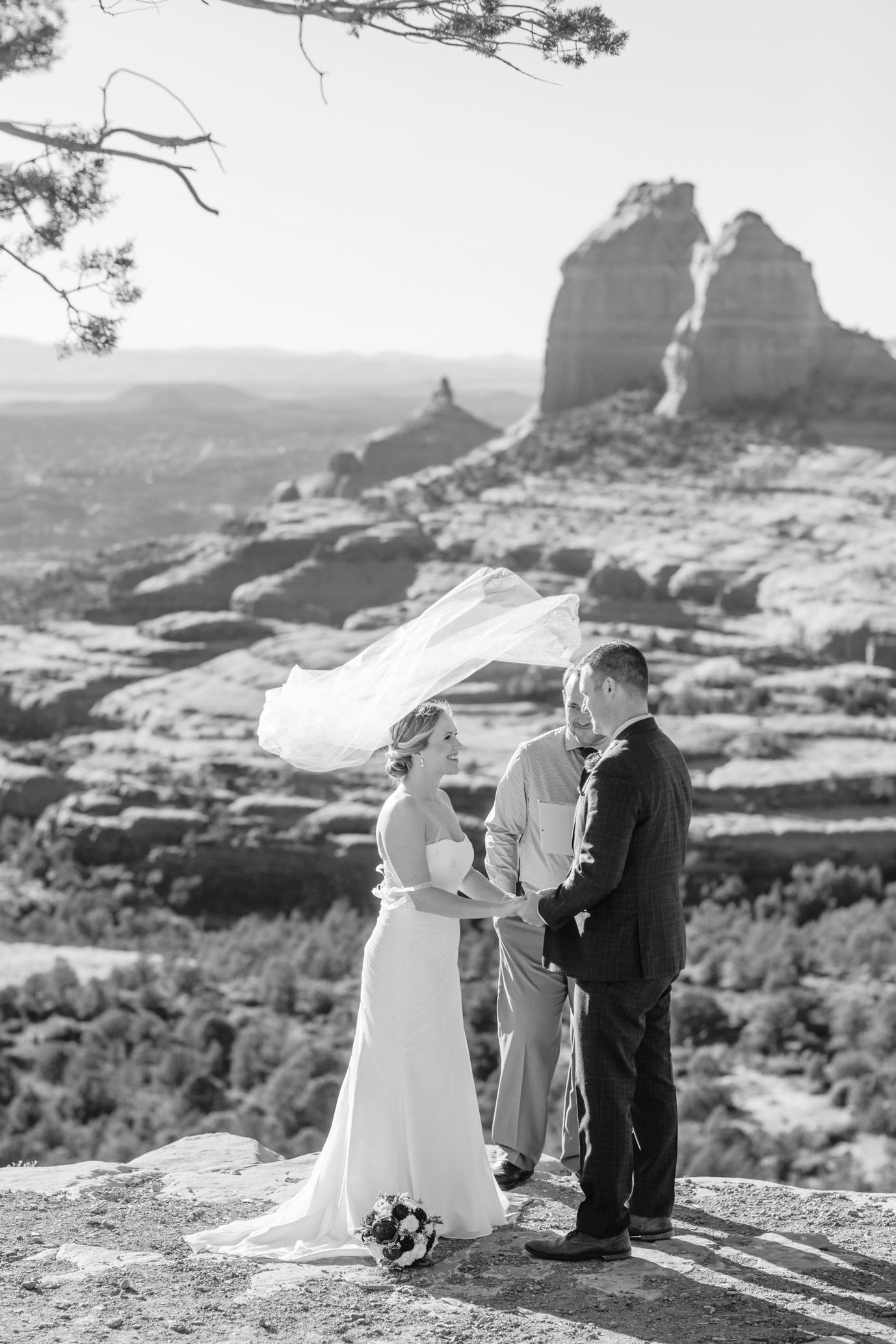 Brides veil flies up in the air during an elopement ceremony at Merry Go Round