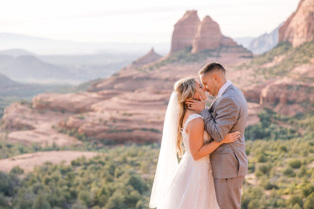 Sedona elopement photography with a bride and groom sharing their first kiss as husband and wife at Merry Go Round. 