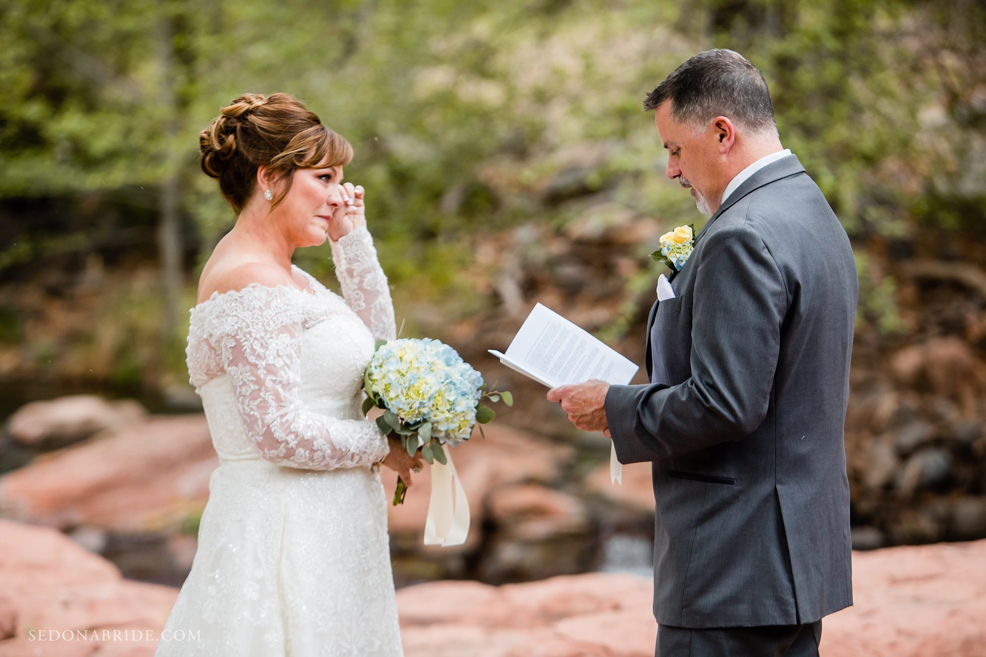 Bride crying as groom reads his vows an elopement at L'Auberge