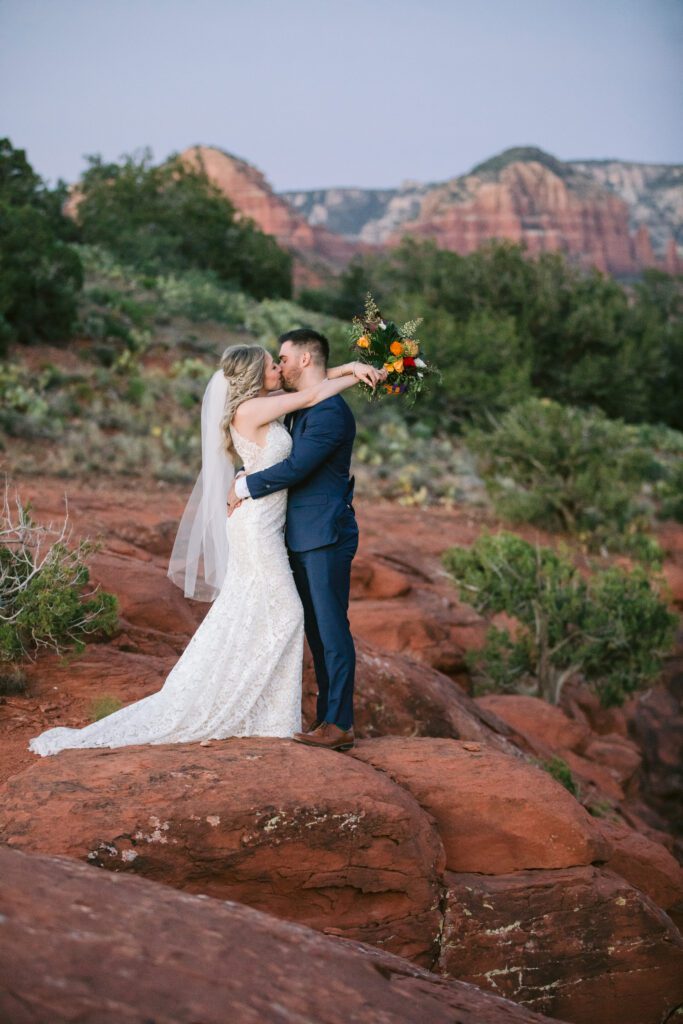 Bride wraps her arms around her grooms neck.