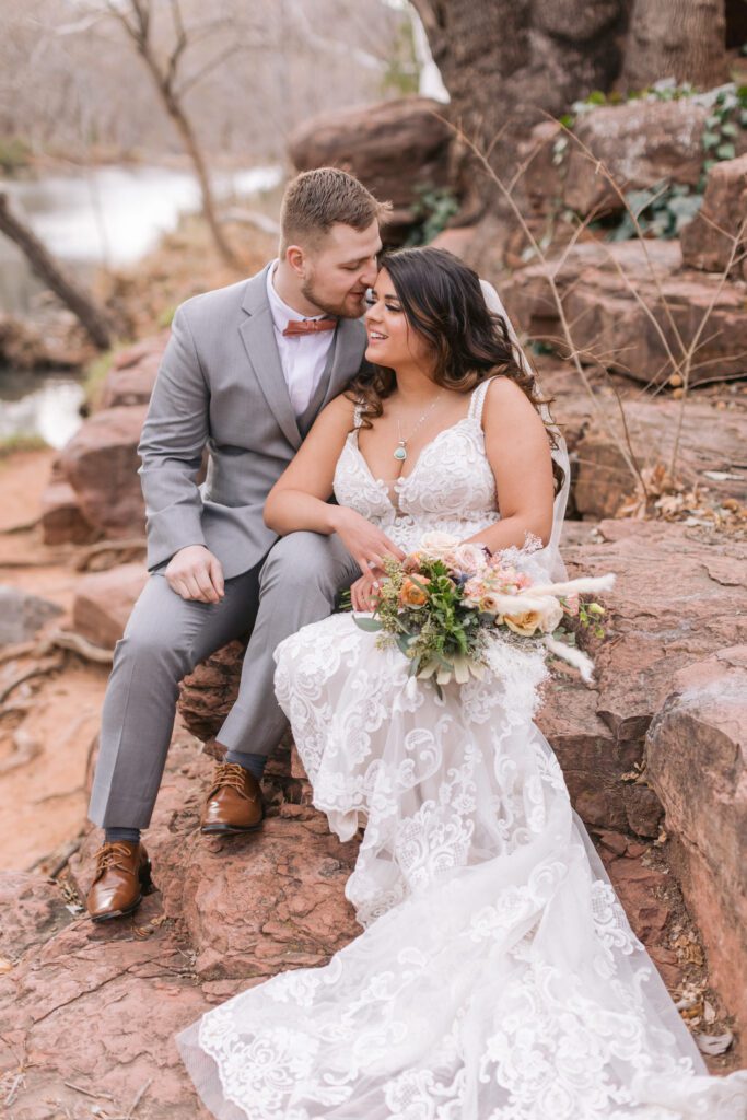 Amara Resort wedding photo of a bride in a white dress holding a wedding bouquet and a groom in a grey suit.